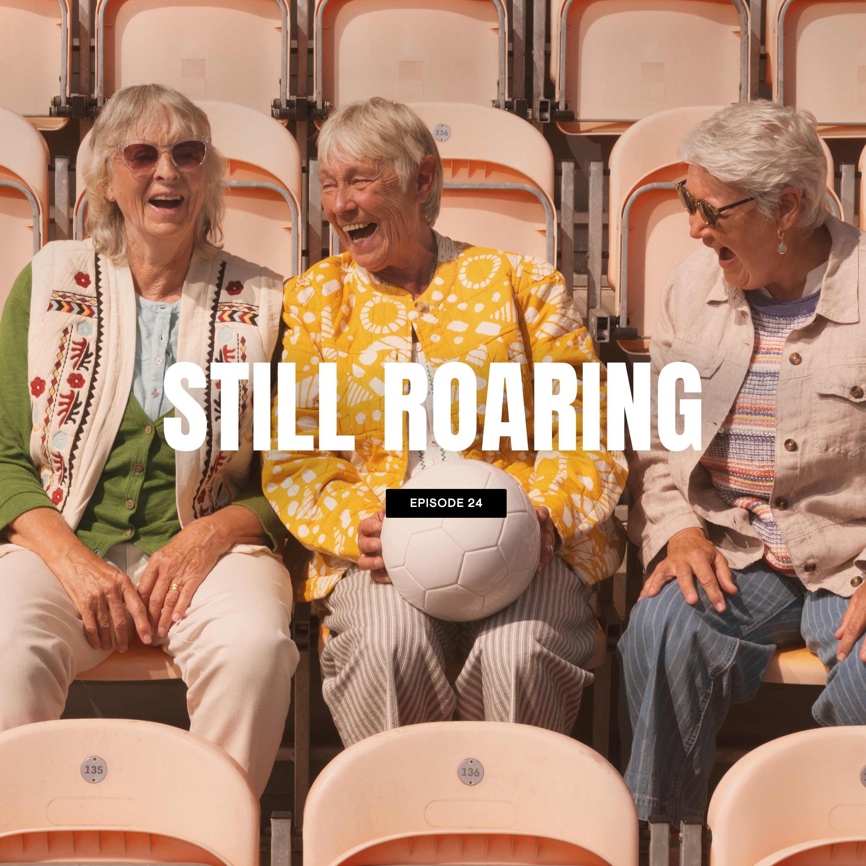 three women sitting in a row of empty seats with a caption reading still roaring