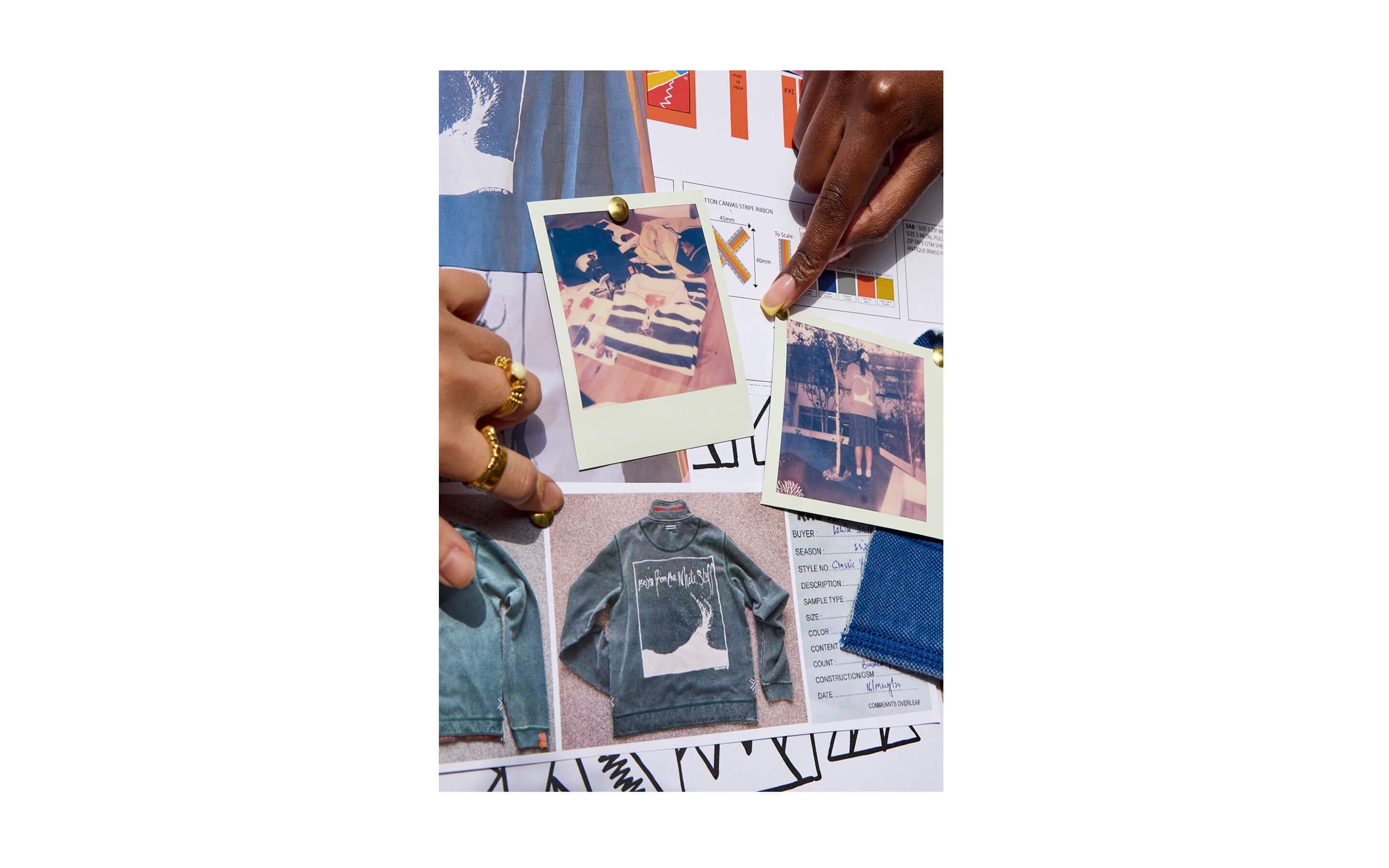 a person is holding a picture of a jacket on a table