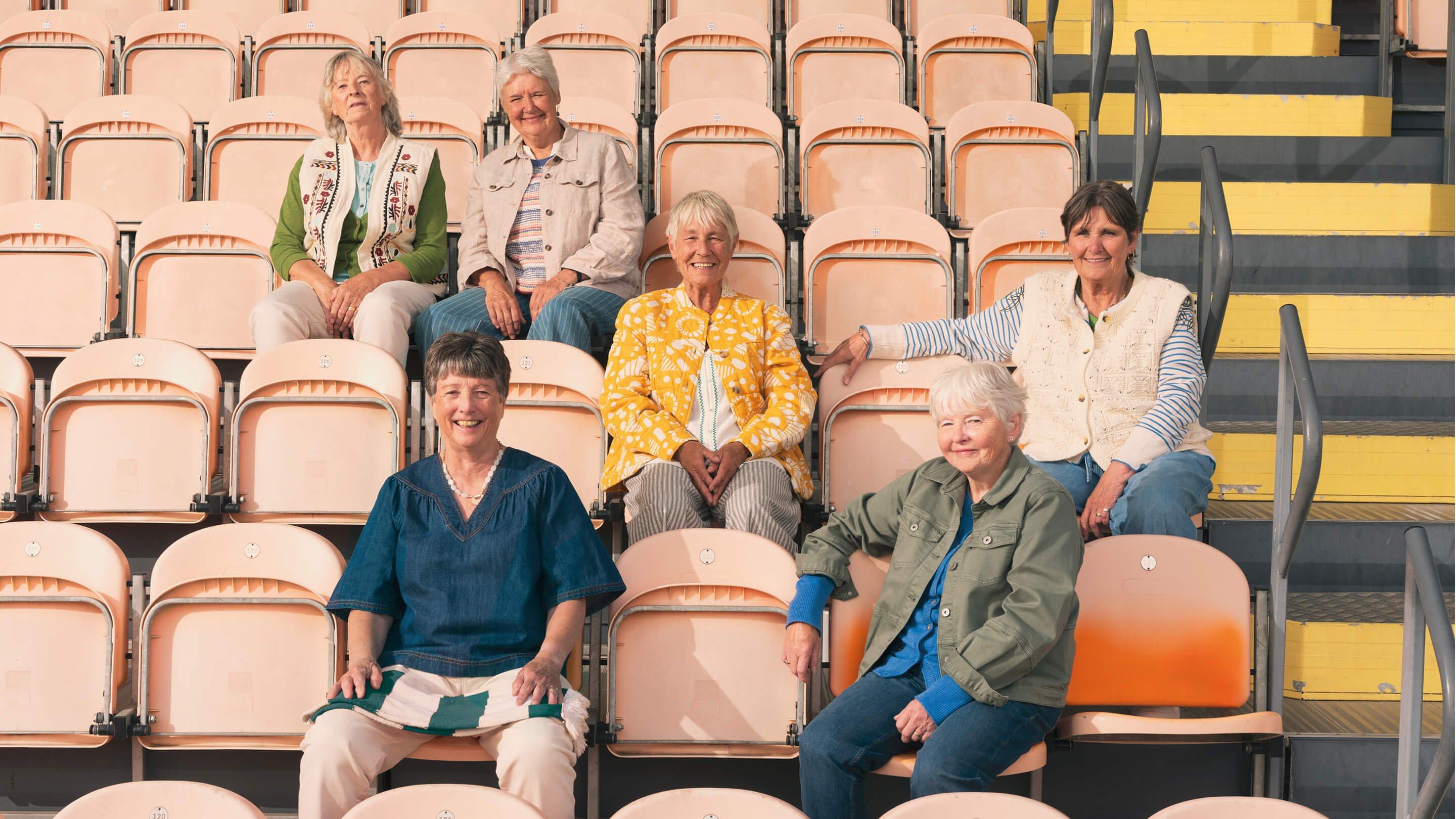 a group of people sitting on bleachers in a stadium