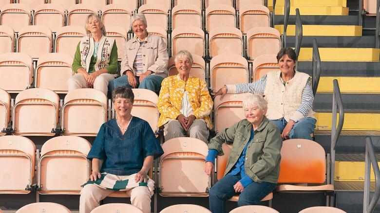 a group of people sitting on bleachers in a stadium