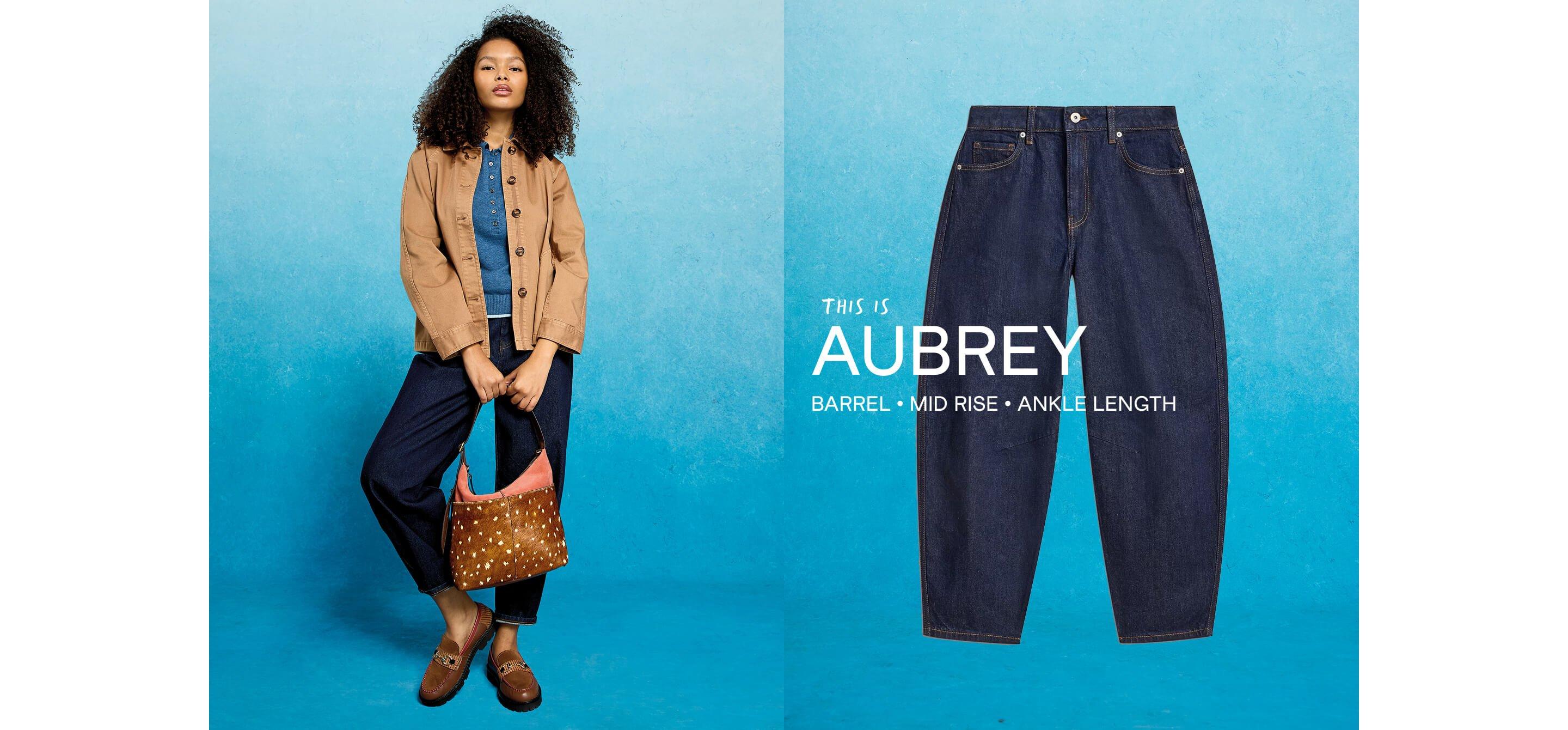 a woman is wearing a brown purse and blue jeans