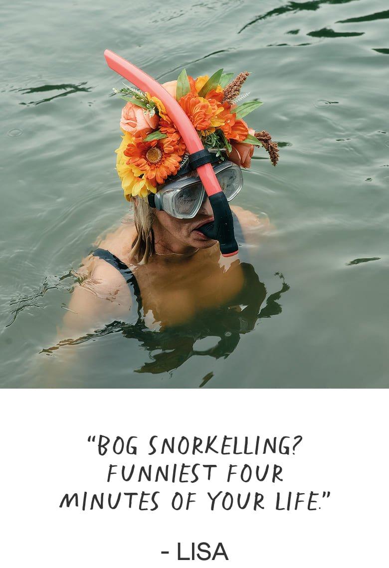 a woman in a wetsuit with a snorkel in the water