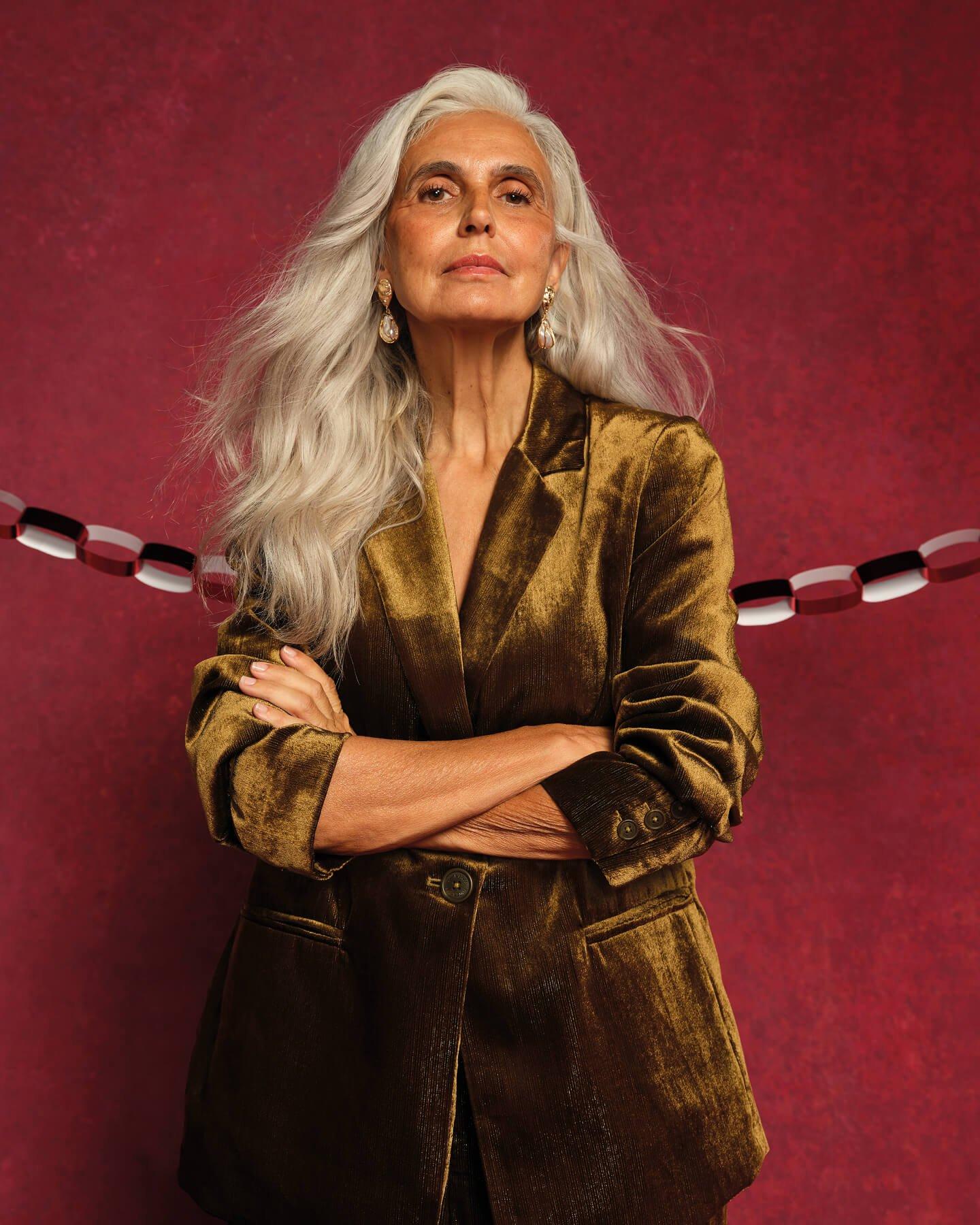 a woman with white hair posing for a portrait