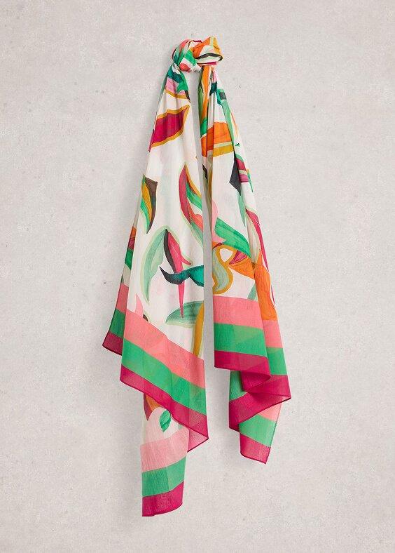 a colorful scarf hanging on a wall with a white background