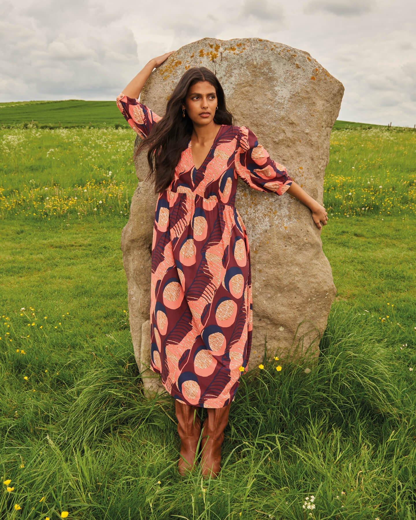 woman leaning on stone