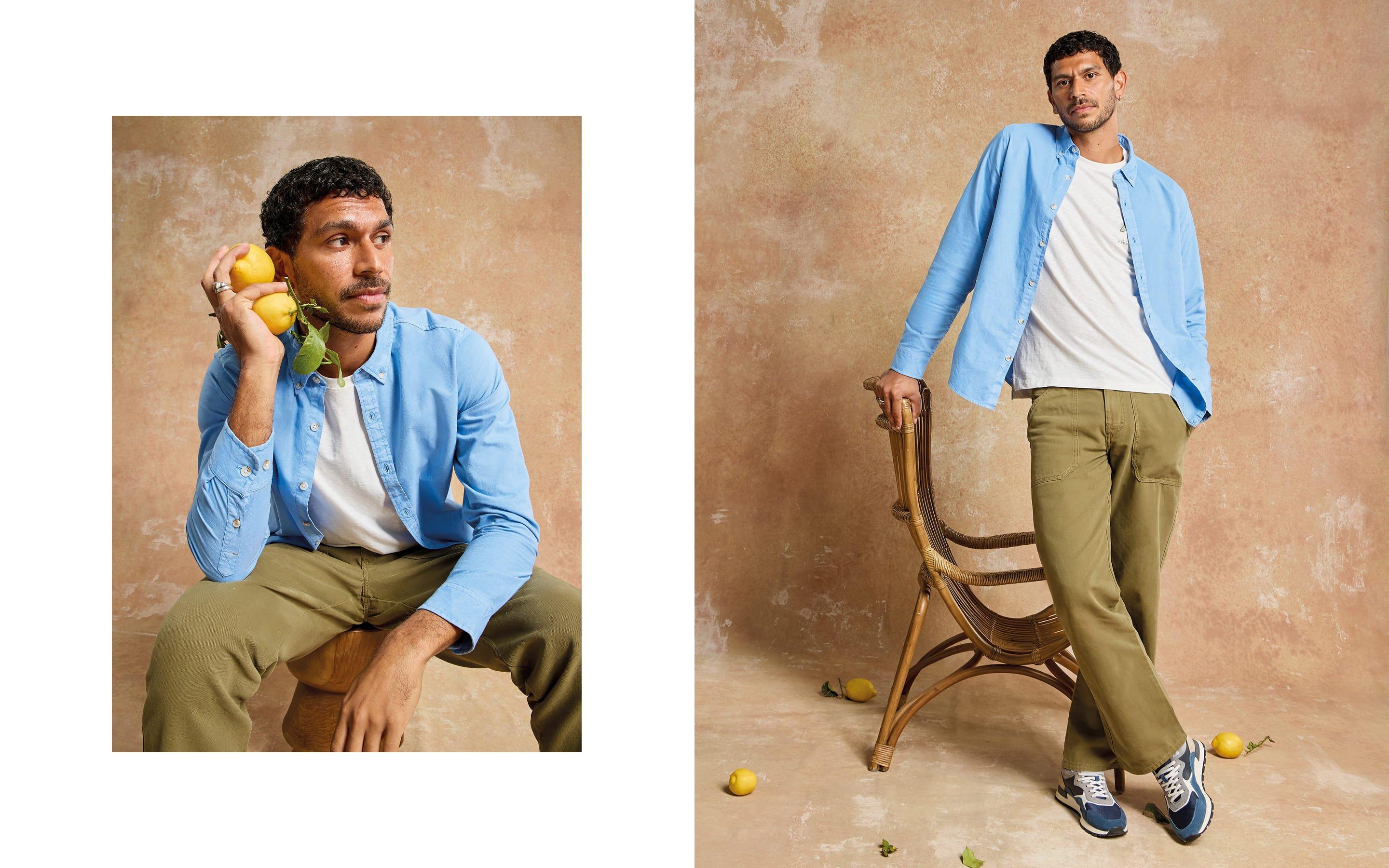 a man in a blue shirt and khaki pants sitting on a chair