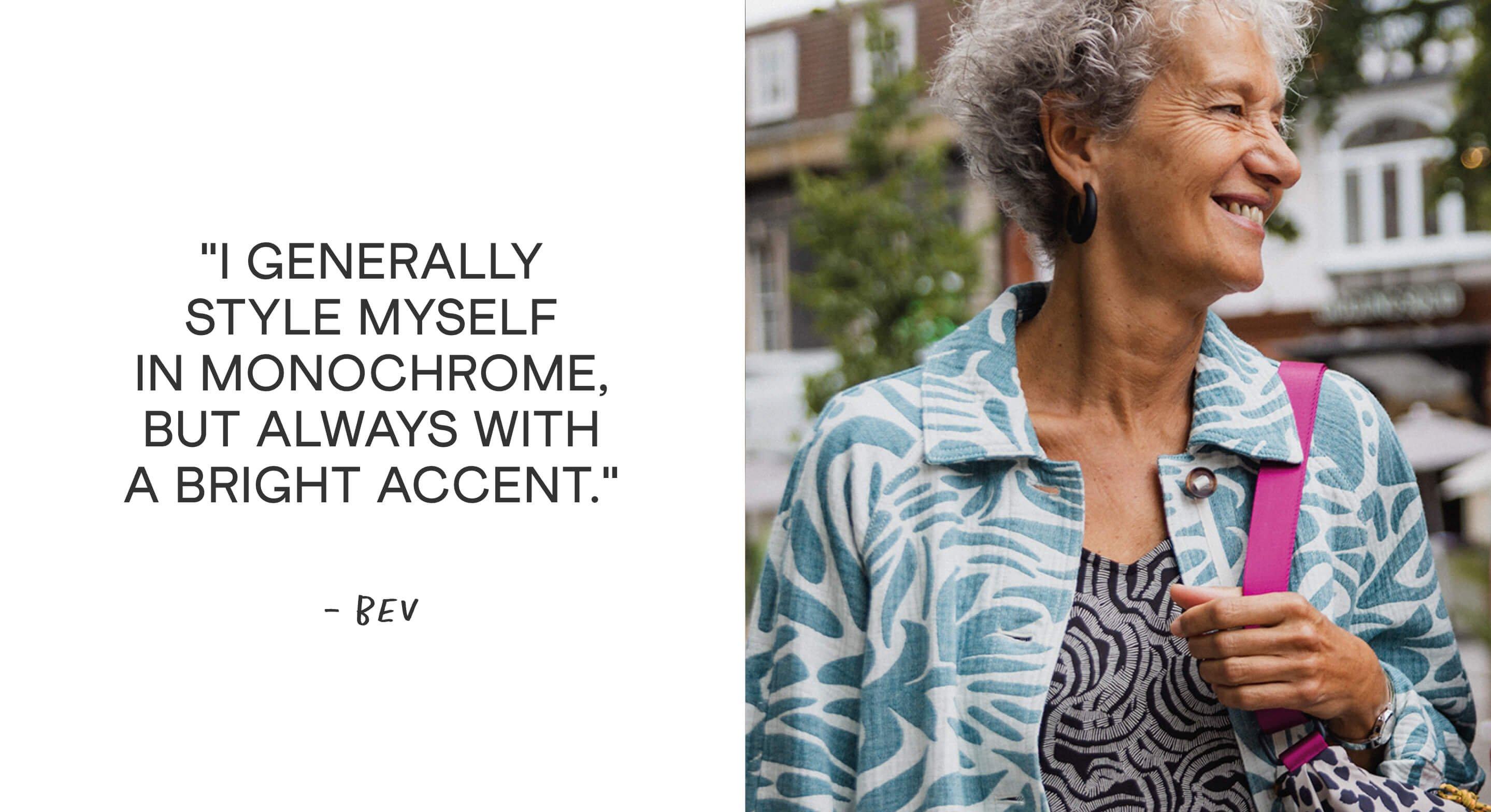 a woman with a smile and a purse is walking down the street