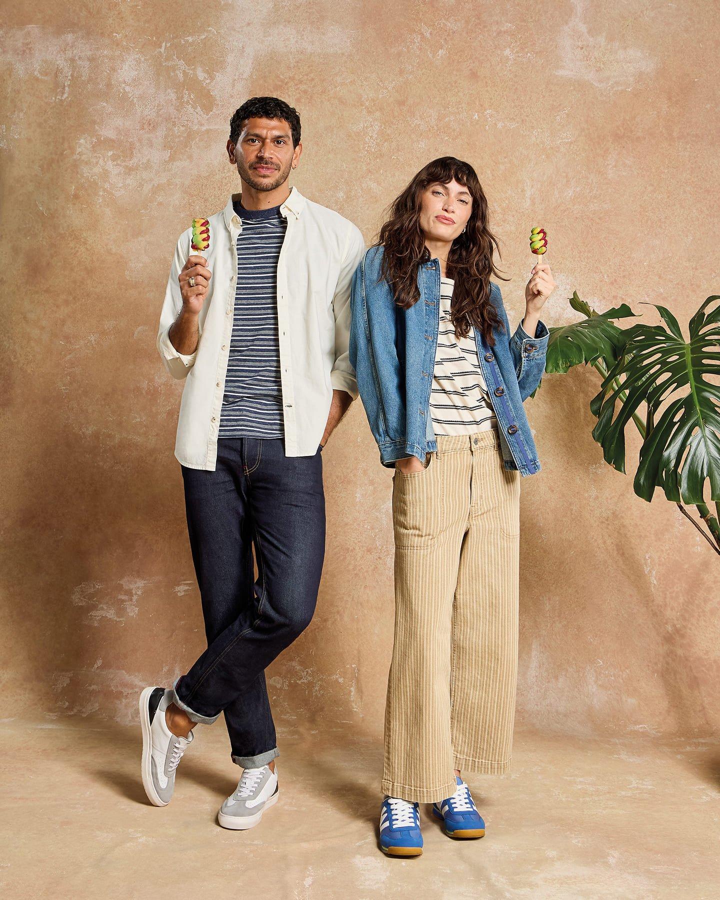 a man and woman standing next to each other holding food