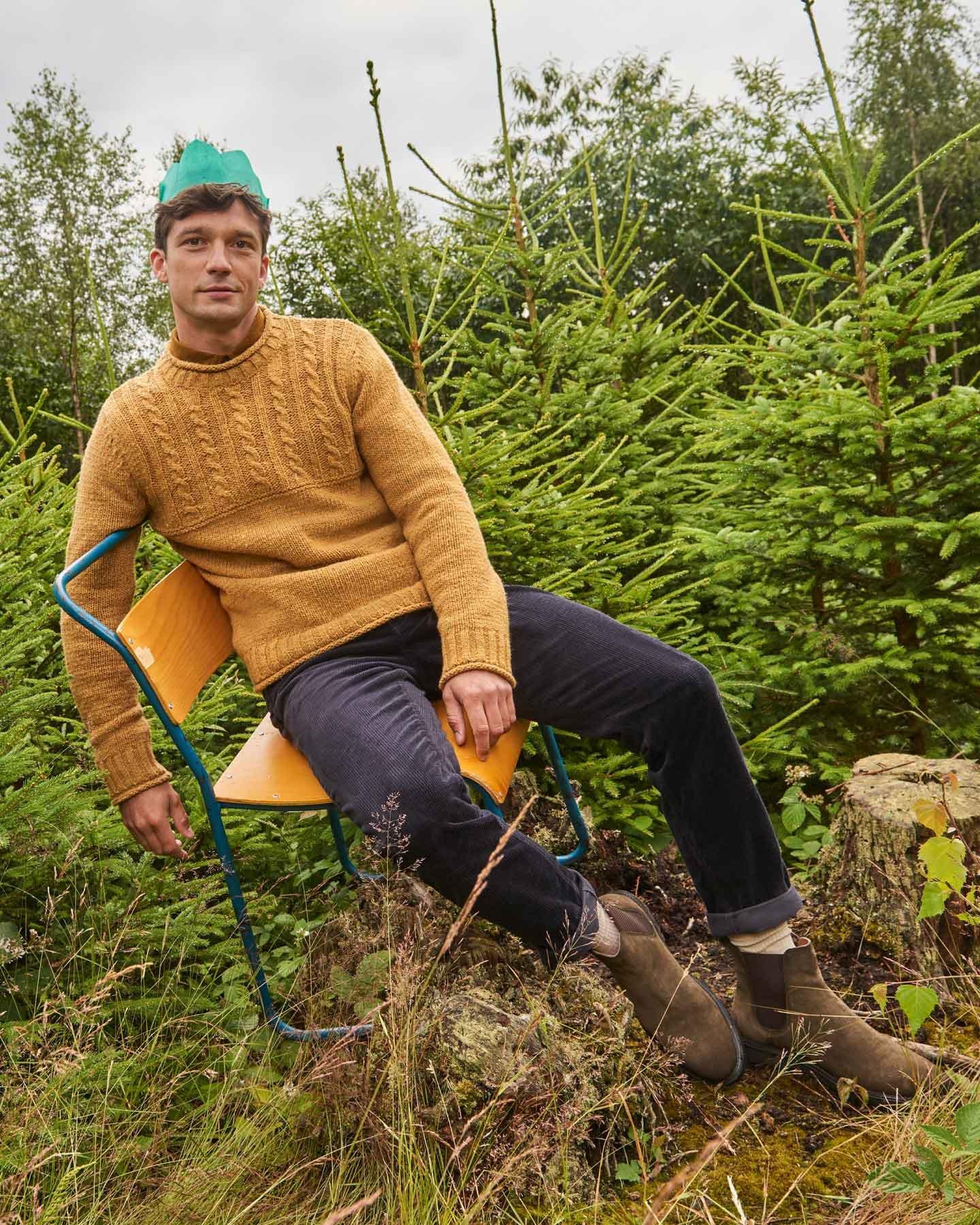 man in jumper on chair