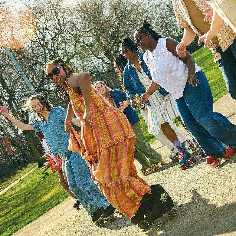 a group of people on roller skates in a park