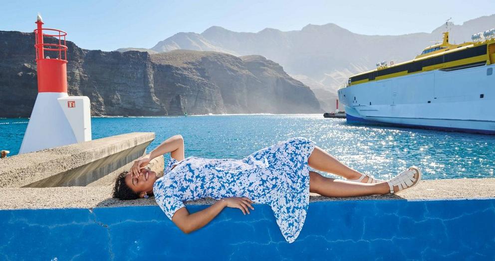 woman lying down in blue pattern summer dress