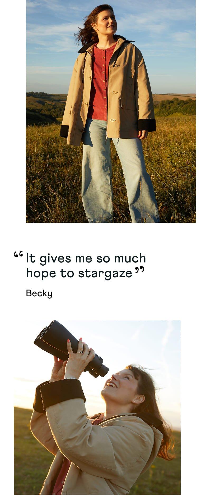 a woman standing in a field with a camera and a bottle of water