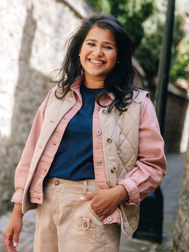 a woman in White Stuff clothes in front of a wall