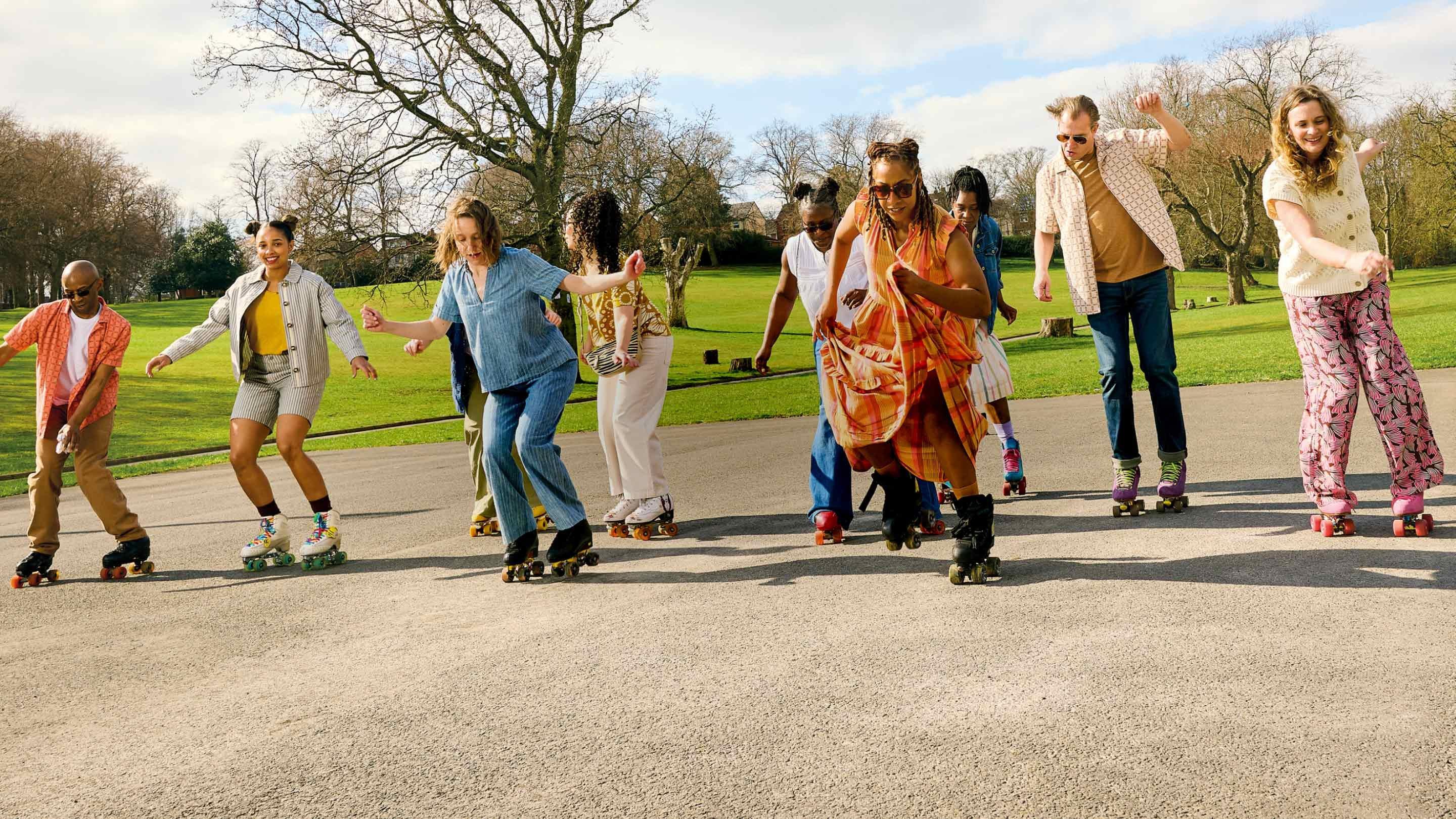 a group of people on roller skates in a park