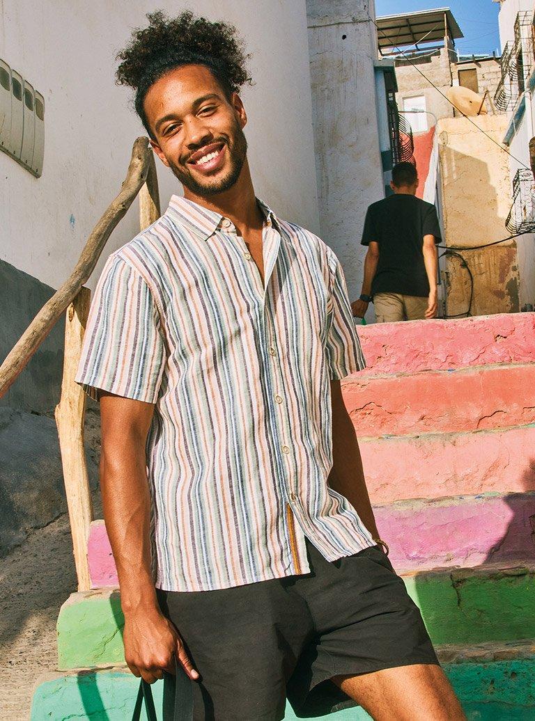 a man with a black bag standing on a set of stairs