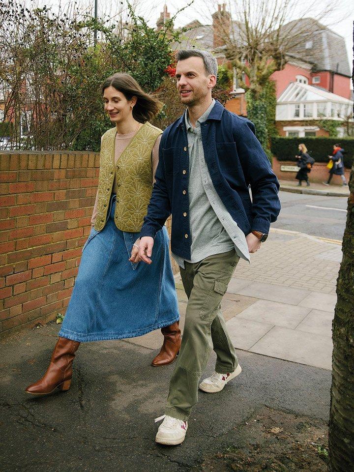 a man and woman walking down a sidewalk 