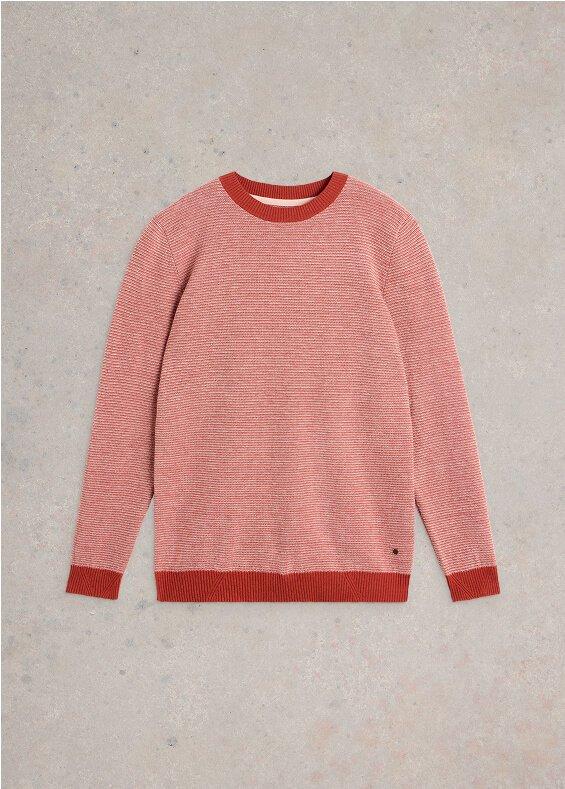 a pink sweater with red stripes on it