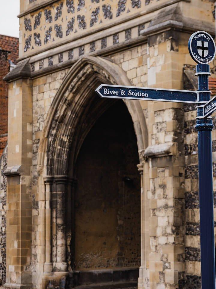a street sign on a pole in front of a church