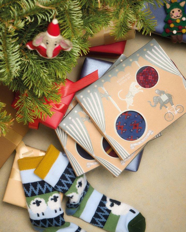 a pile of socks and presents under a christmas tree