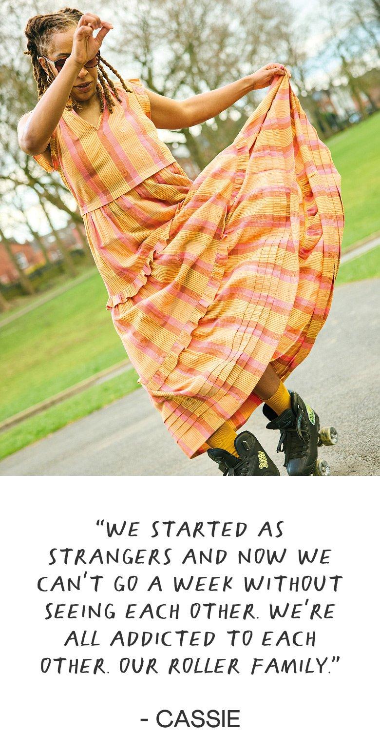 a woman in a dress is roller skating on a sidewalk
