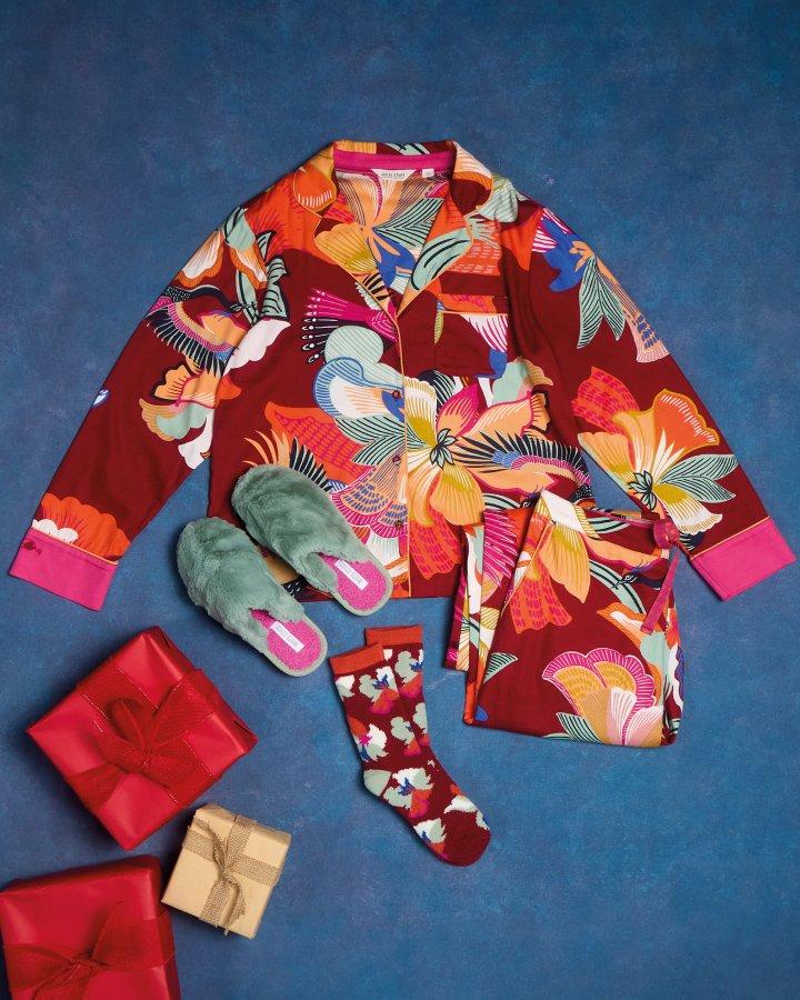 a red and green pyjamas and matching slippers are laid out