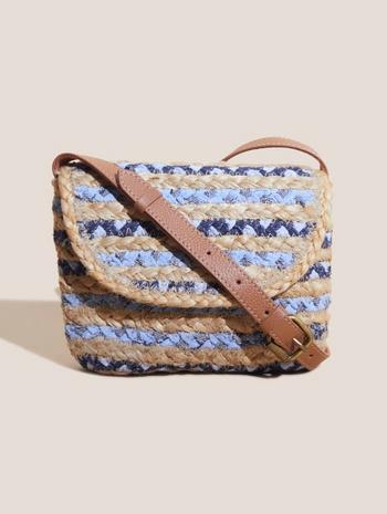 the small woven bag is made from blue and white striped fabric