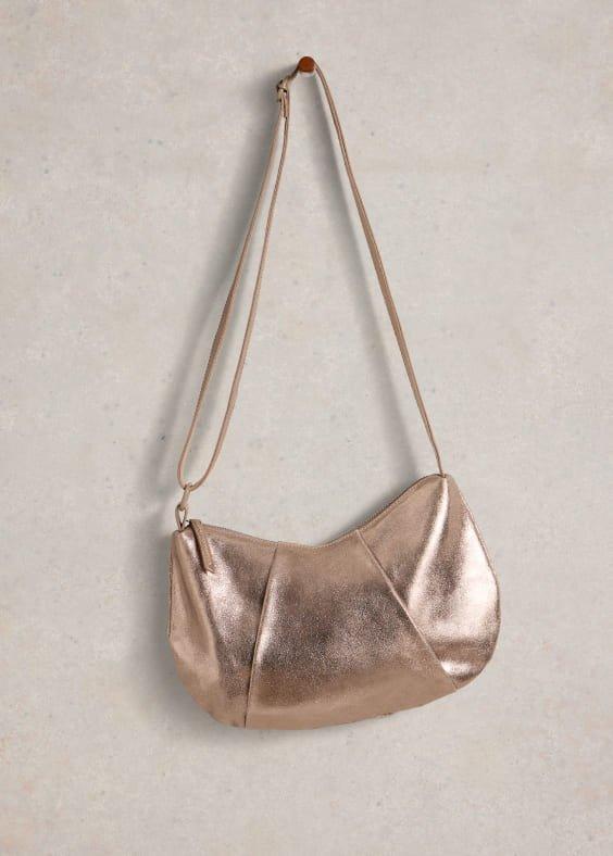 a metallic purse hanging on a wall