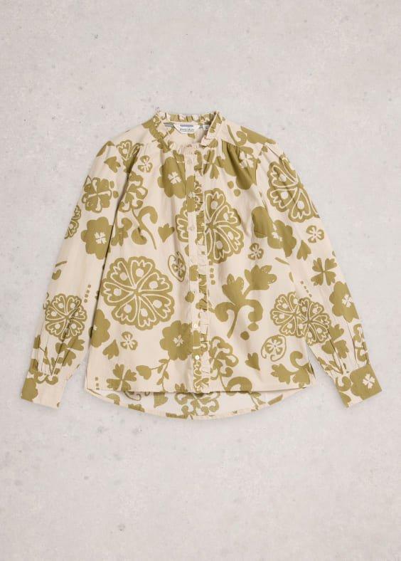 a shirt with a green and white floral print on it