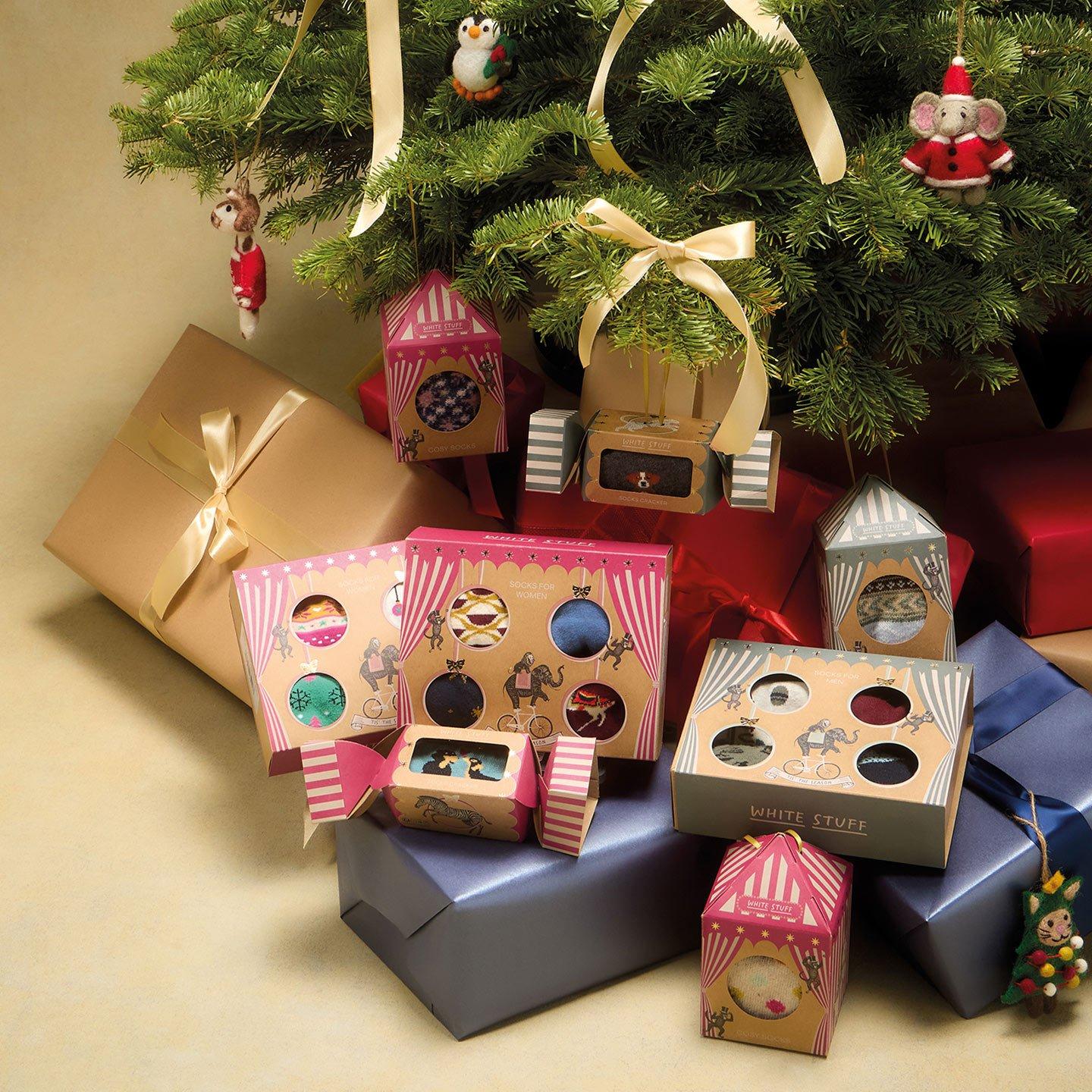 a pile of presents under a christmas tree with a christmas tree