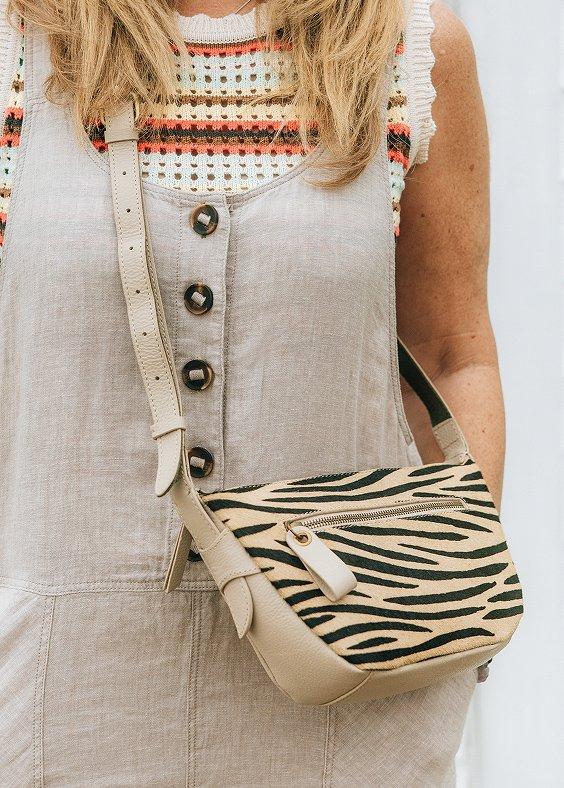 a woman wearing overalls and a zebra print purse by White Stuff