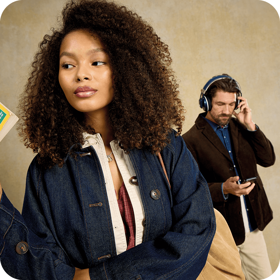 a man and woman in a studio with a book and headphones