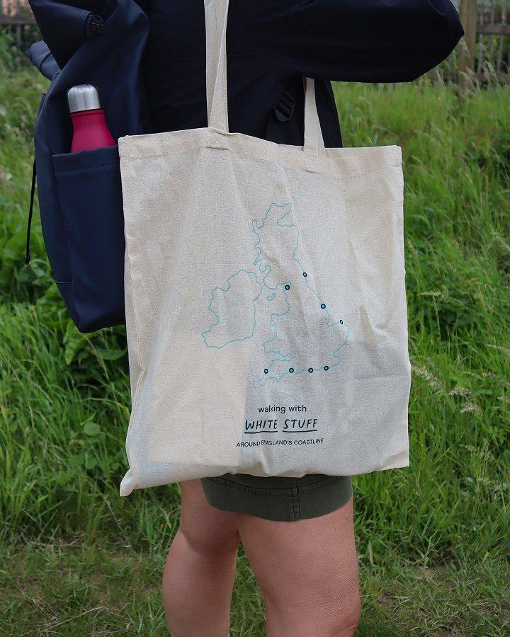 a woman with a backpack and a map on her shoulder