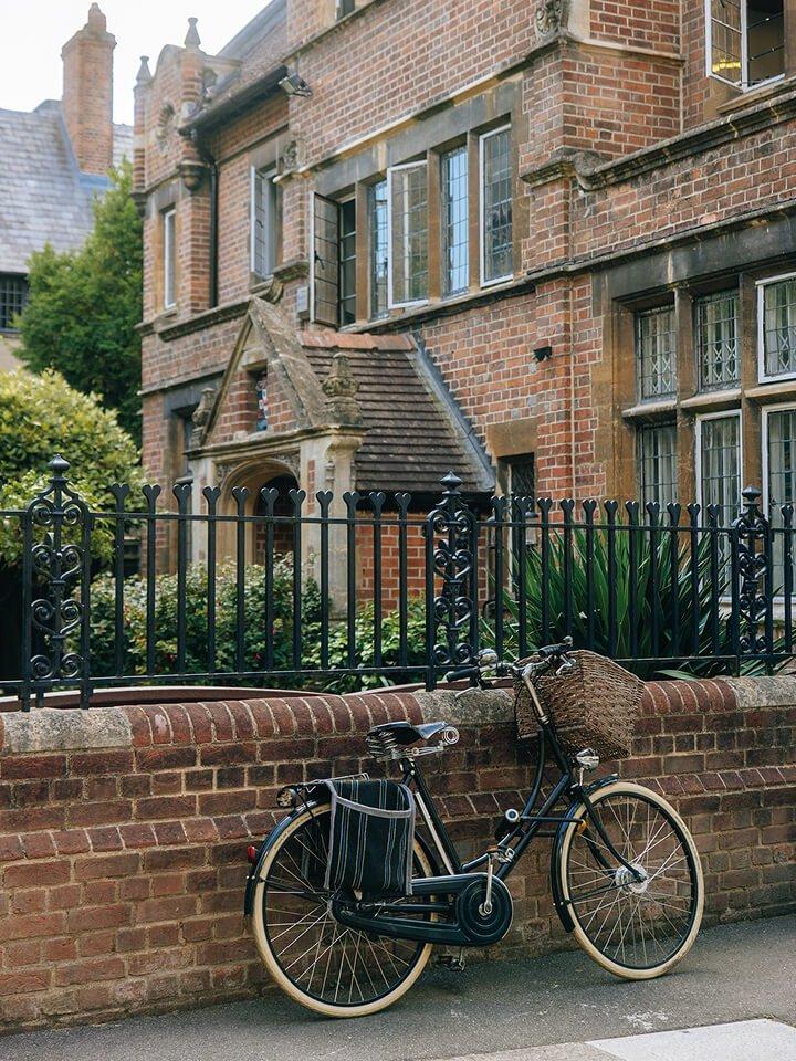 a bike leaning on a reiling in front of a building 