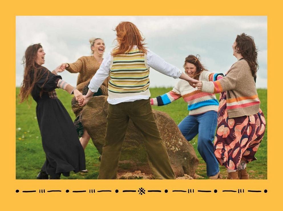 women dancing around an ancient stone