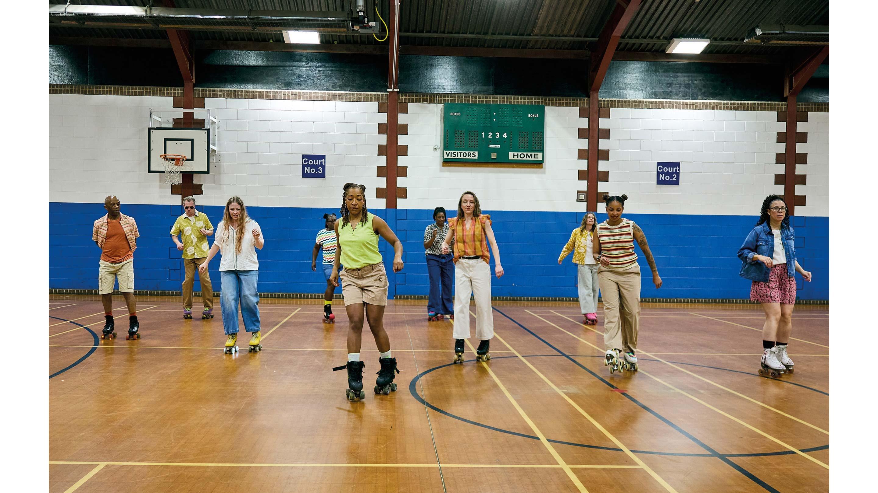 a group of people on roller skates in a gymnasium