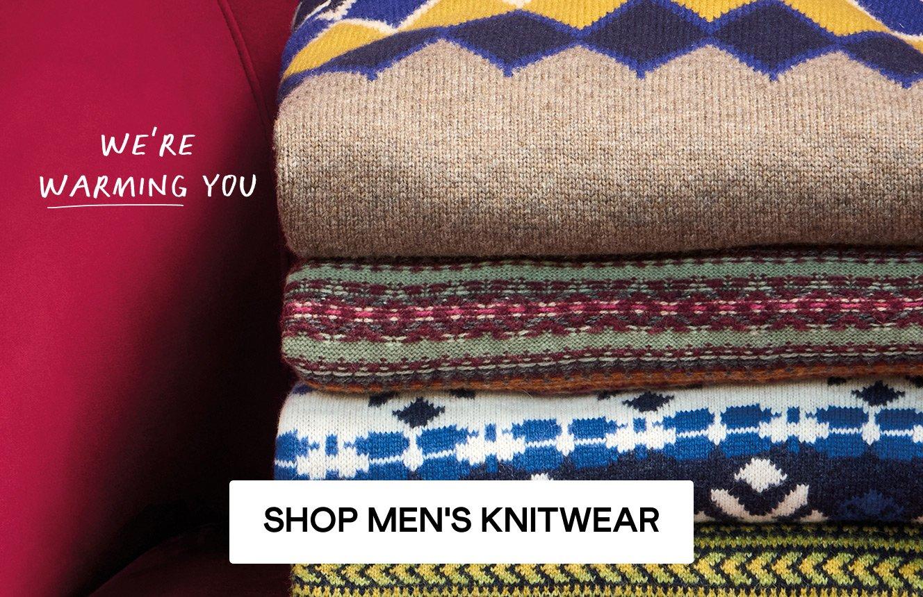 A stack of jumpers. Click here to shop men's knitwear.