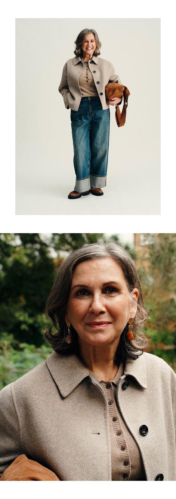 a woman in a jacket and jeans holding a purse