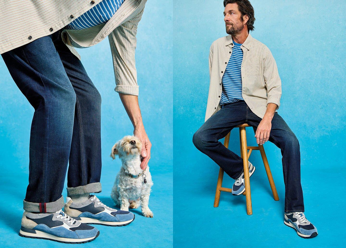 a man sitting on a stool with a dog