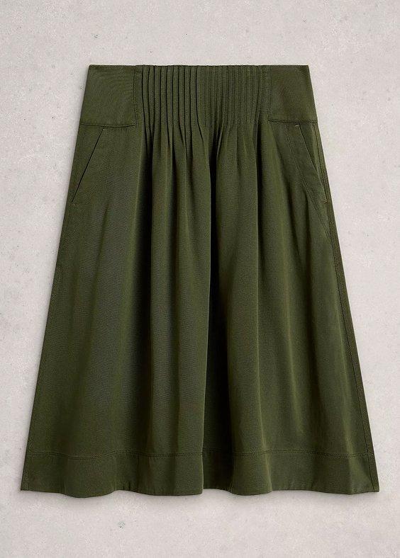 a green skirt with a pleated waist and pockets