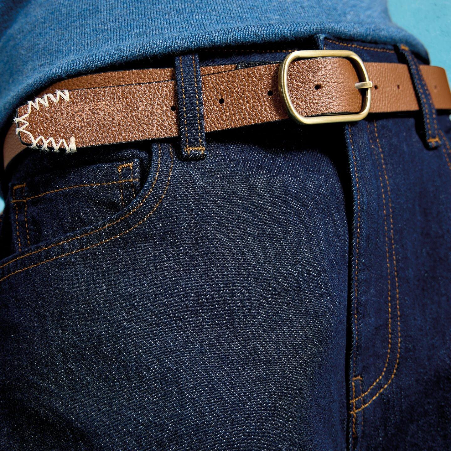 a close up of a person's jeans with a belt