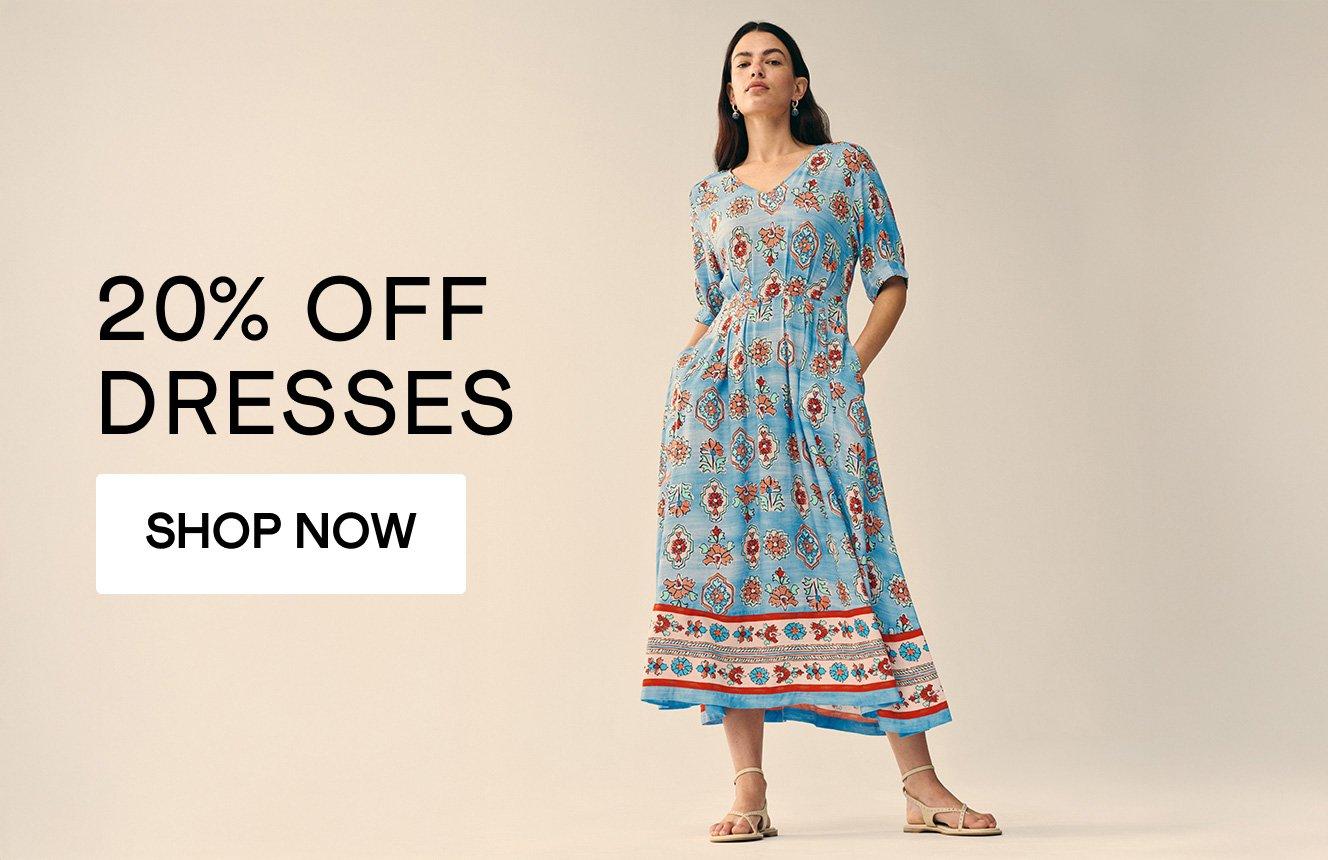 a woman wearing a dress with the text 20% off dresses, click here to shop.