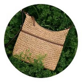 a woven bag sitting on top of a green grassy area