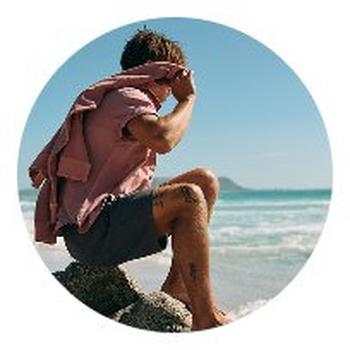 a man walking on a rock by the ocean