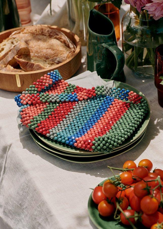 a table topped with a variety of food and a plate of tomatoes