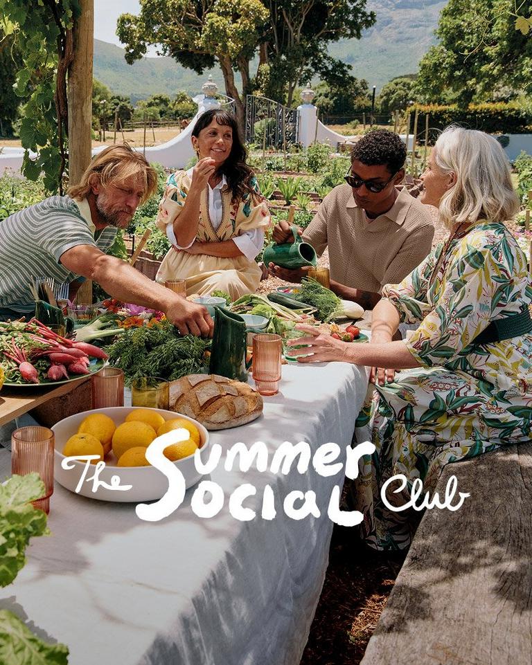 Video of a group of people in a garden sharing food