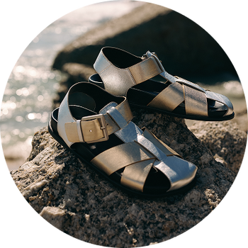 a pair of a pair of sandals sitting on top of a rock
