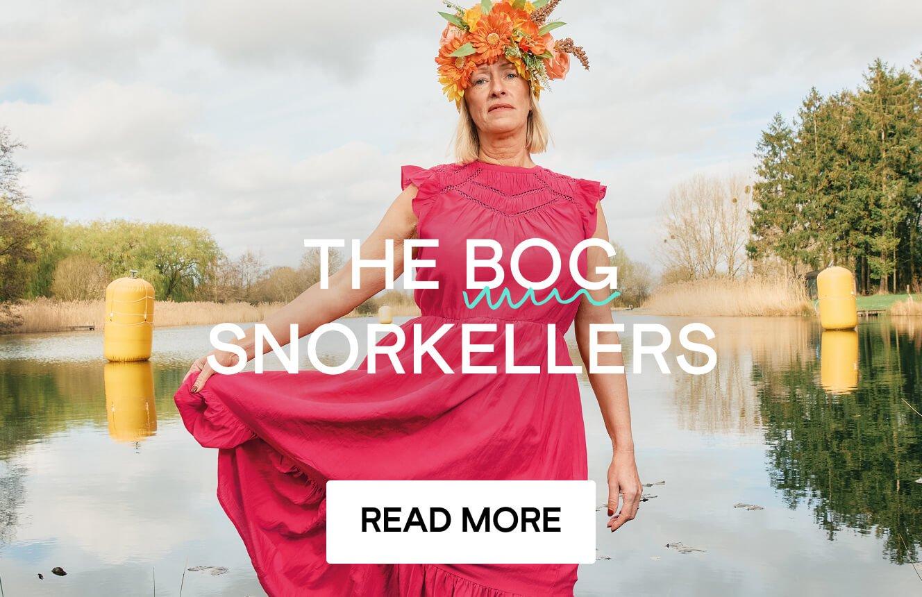 A woman in a pink dress and flower crown standing in water. The text reads "The Bog Snorkellers - Read more"