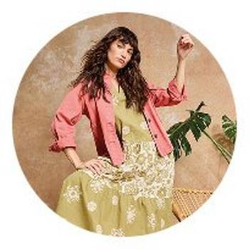 a woman in a dress and jacket posing in a circle
