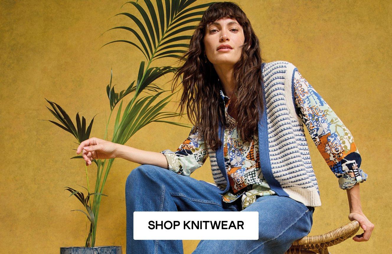 A woman wearing the Kyle Waistcoat, the Sophie Shirt and the Ayla Wide Leg Jeans. Click here to shop knitwear.