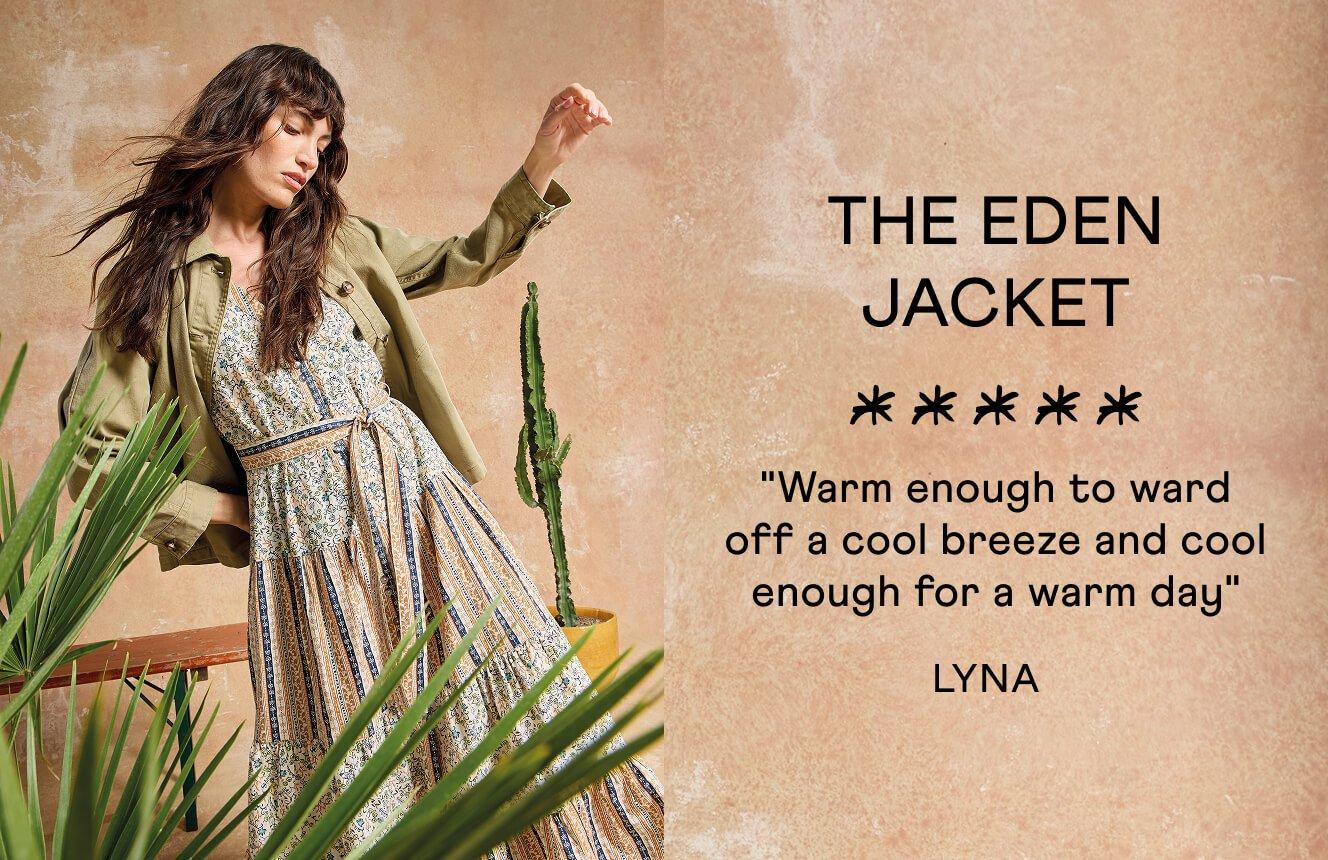 A woman wearing the green Eden Denim Jacket over the beige Clementine dress. Text on the image is a 5 star review by Lyna:"Warm enought to ward off a cool breeze and cool enough for a warm day".